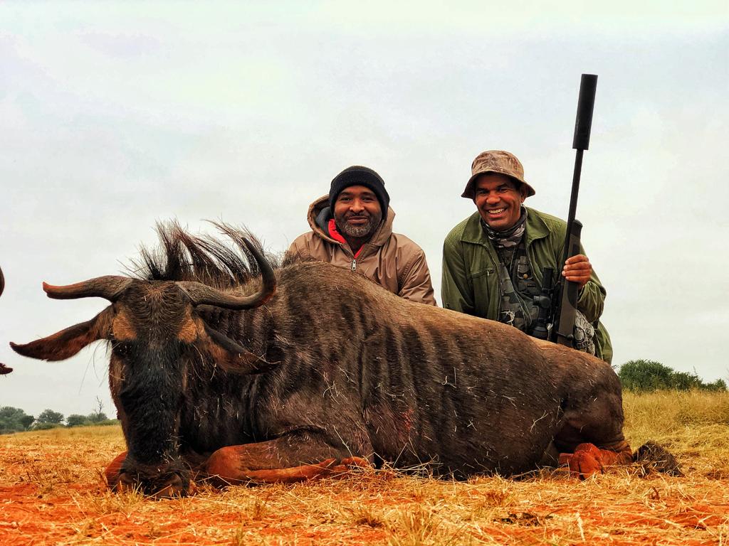 Hunter with blue wildebeest trophy at Maxi Ranch
